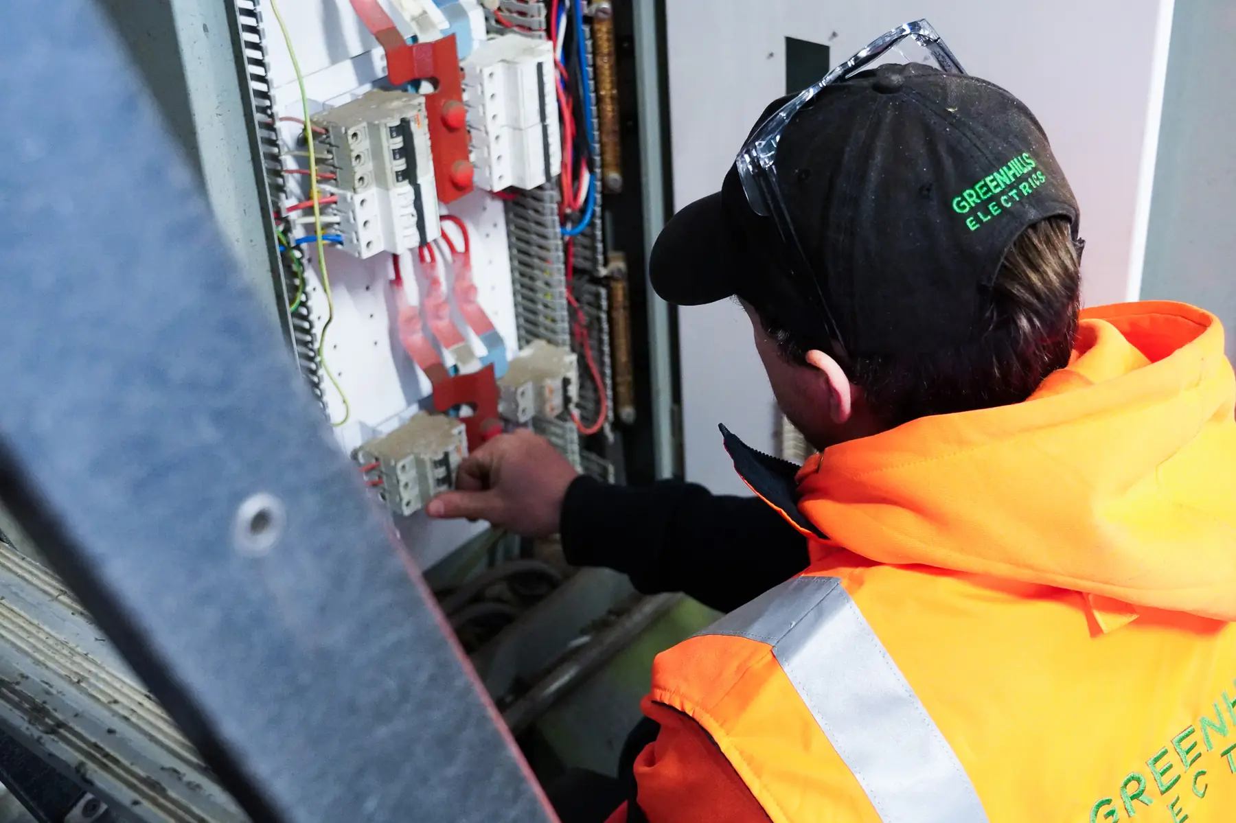 Greenhills electrician working on a switchboard